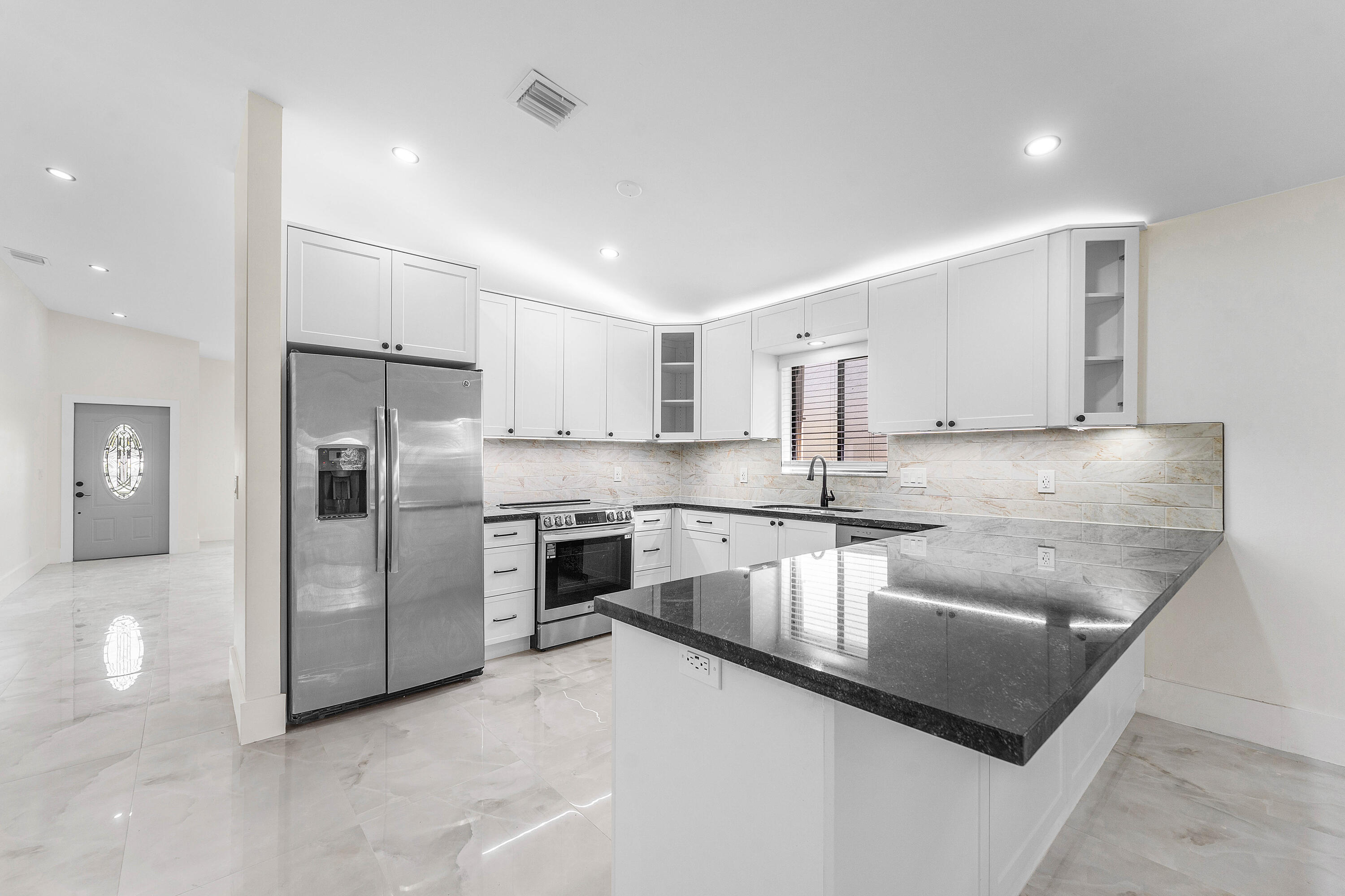 1531 Southwest 102nd Terrace Davie, FL 33324 - Photo 9 of 30 a kitchen with stainless steel appliances granite countertop a sink a stove and a refrigerator