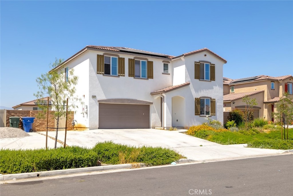 9667 Lasorda Court Riverside, CA 92503 - Photo 1 of 34 a view of a white house with a yard and potted plants