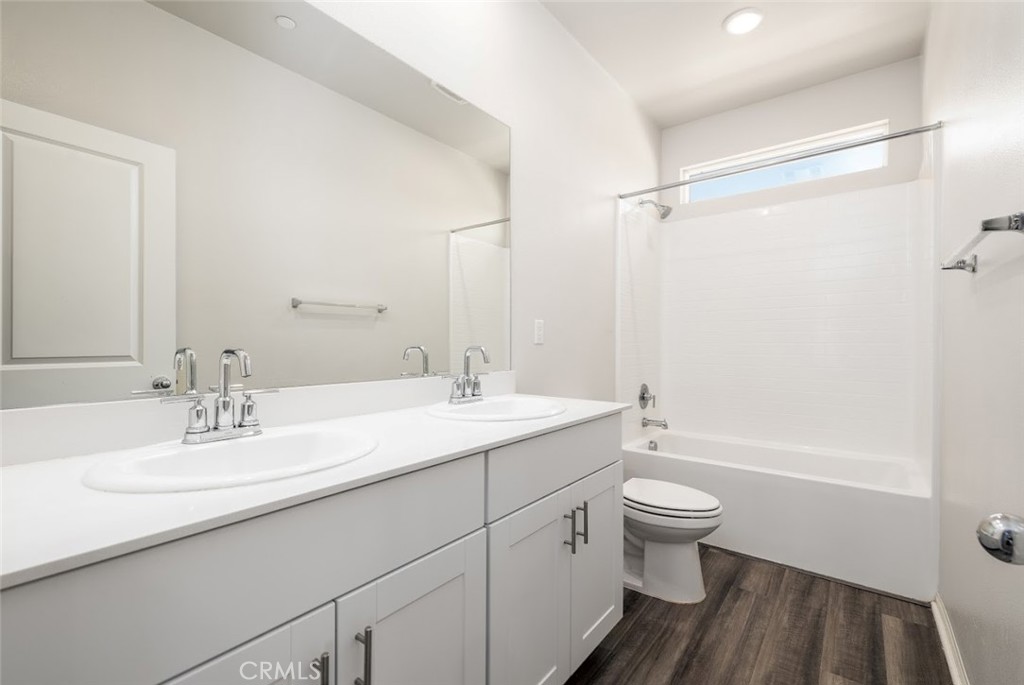 9667 Lasorda Court Riverside, CA 92503 - Photo 19 of 34 a bathroom with a sink a toilet and shower