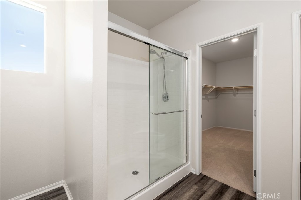9667 Lasorda Court Riverside, CA 92503 - Photo 25 of 34 a bathroom with a glass shower door
