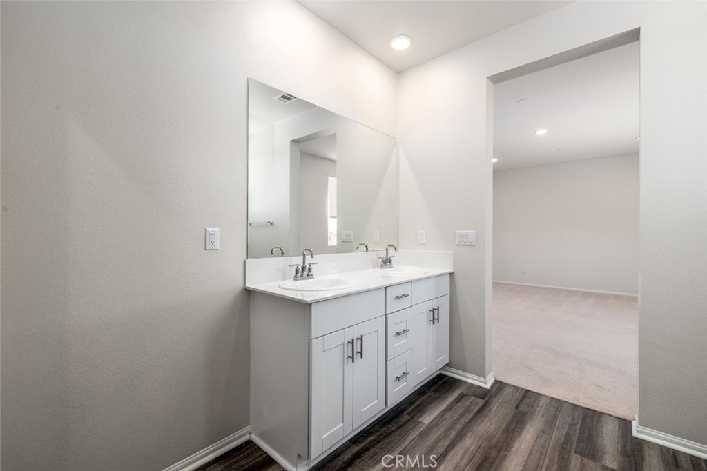 9667 Lasorda Court Riverside, CA 92503 - Photo 26 of 34 a spacious bathroom with a double vanity sink a mirror and a