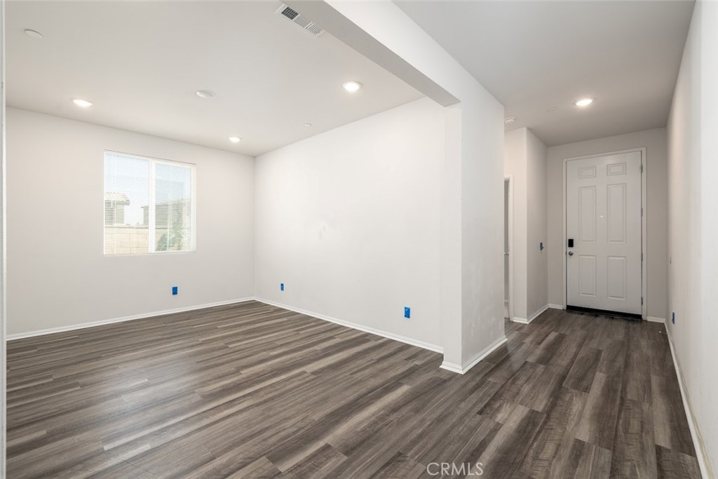 9667 Lasorda Court Riverside, CA 92503 - Photo 4 of 34 a view of an empty room with wooden floor and a window