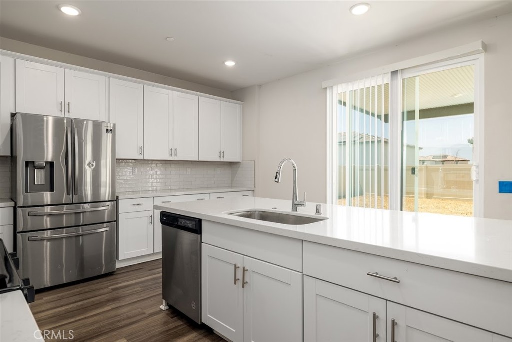 9667 Lasorda Court Riverside, CA 92503 - Photo 8 of 34 a kitchen with a refrigerator and window