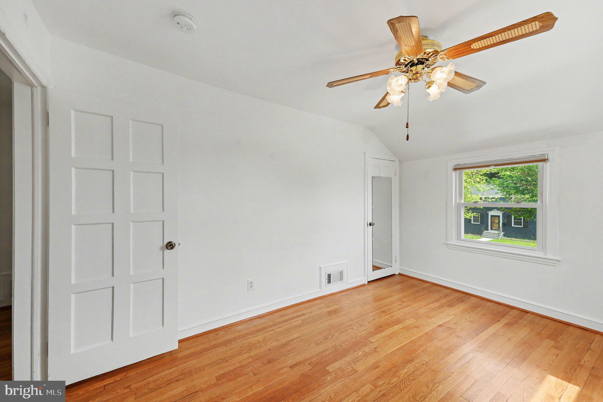 4504 20th Street Northeast Washington, DC 20018 - Photo 15 of 39 an empty room with wooden floor fan and windows