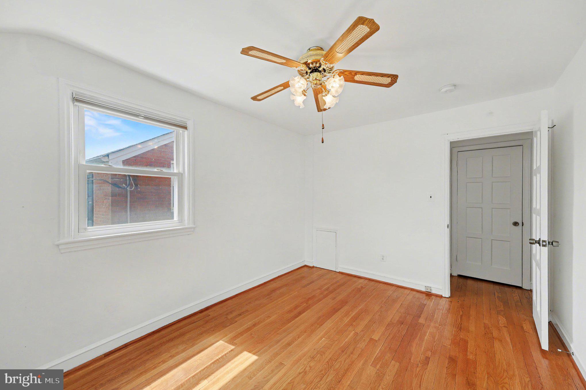 4504 20th Street Northeast Washington, DC 20018 - Photo 16 of 39 a view of an empty room with wooden floor and a window