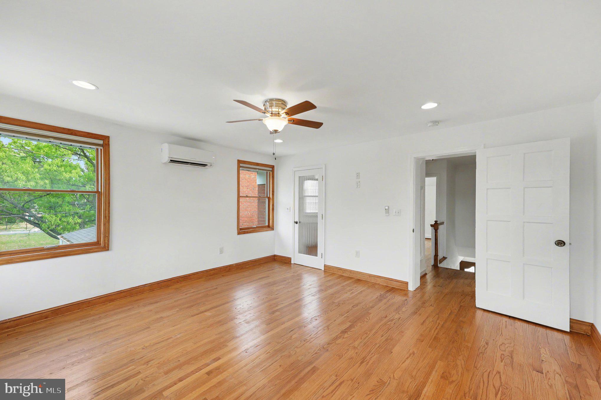 4504 20th Street Northeast Washington, DC 20018 - Photo 17 of 39 a view of an empty room with a window and wooden floor