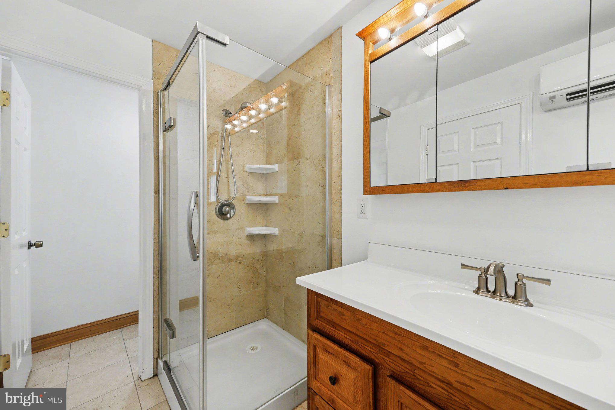 4504 20th Street Northeast Washington, DC 20018 - Photo 22 of 39 a bathroom with a sink a toilet and shower