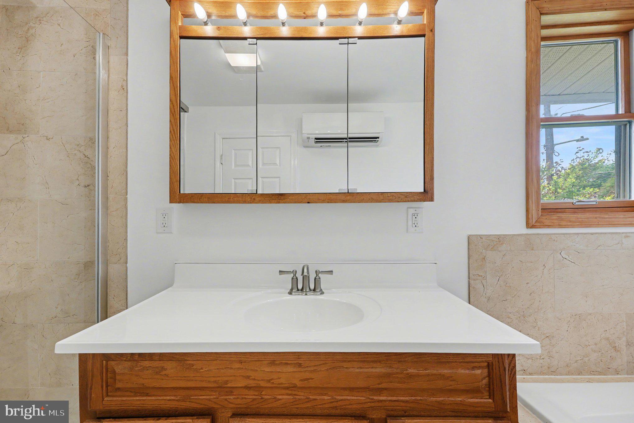 4504 20th Street Northeast Washington, DC 20018 - Photo 23 of 39 a bathroom with a sink and a mirror