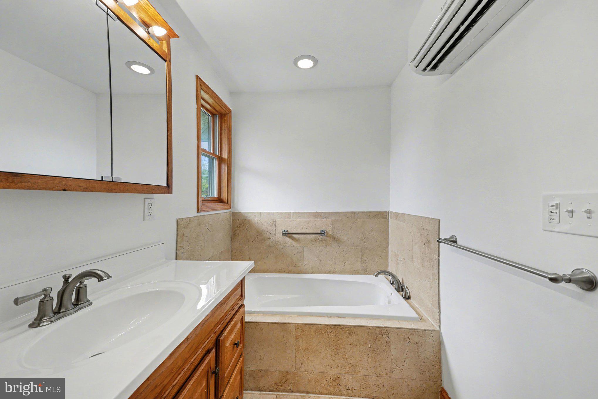 4504 20th Street Northeast Washington, DC 20018 - Photo 24 of 39 a bathroom with a bathtub and a sink
