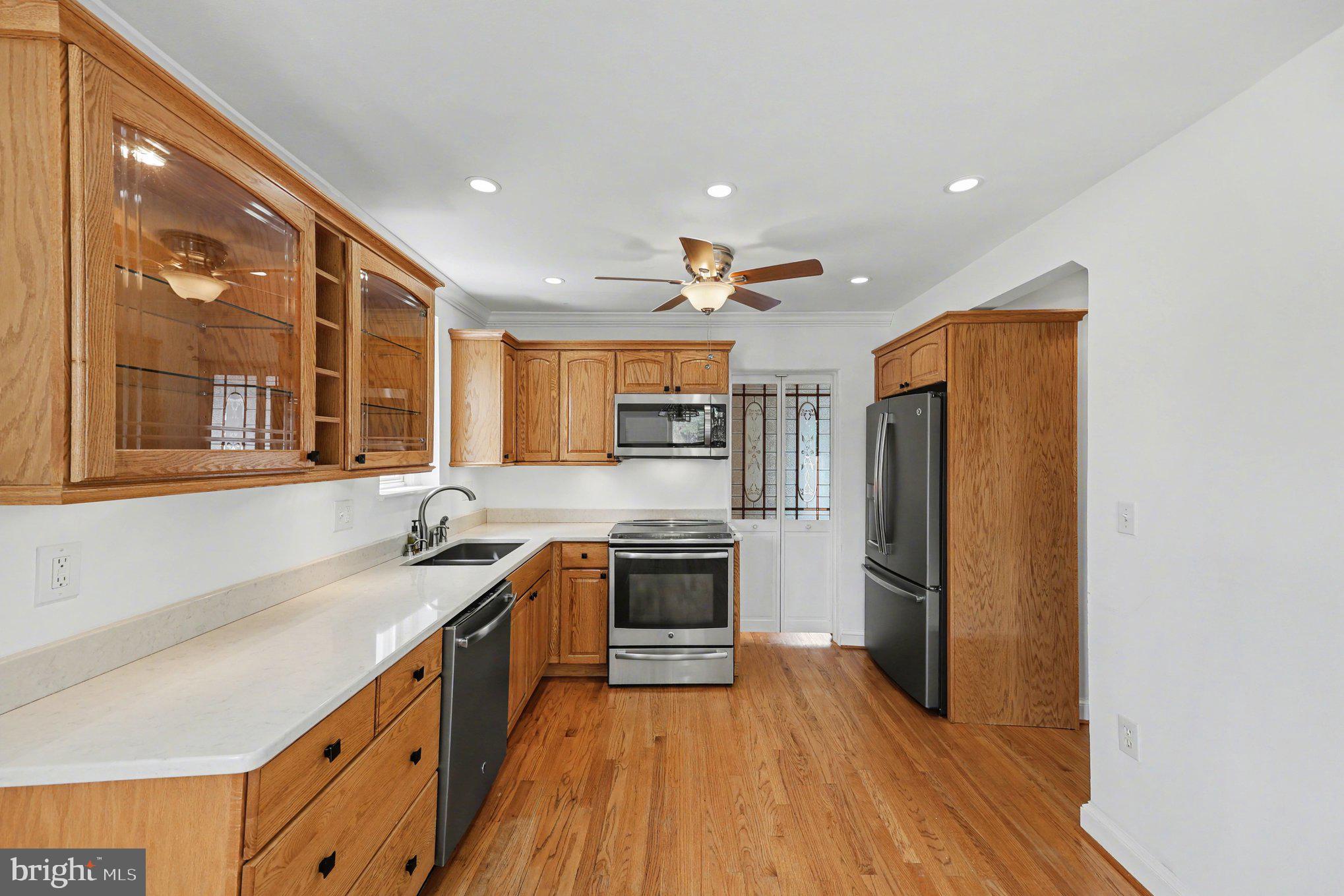 4504 20th Street Northeast Washington, DC 20018 - Photo 9 of 39 a kitchen with stainless steel appliances granite countertop a refrigerator a sink dishwasher a stove and white countertops with wooden floor