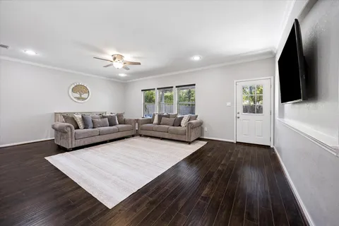 a living room with furniture and wooden floor