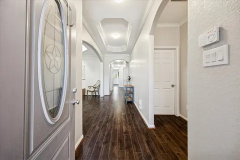a view of a hallway with wooden floor