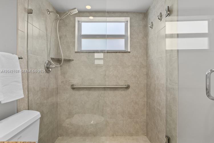 3213 Colony Club Road, Unit 3E Pompano Beach, FL 33062 - Photo 22 of 31 a bathroom with a shower and toilet
