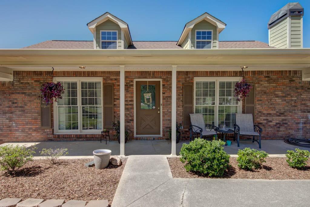 front view of a brick house with a small yard