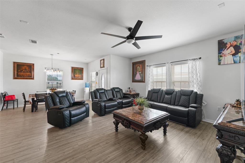 0 Ewing Road Ferris, TX 75125 - Photo 7 of 29 Open-concept living area with wood-finish flooring, recessed lighting, and a modern ceiling fan