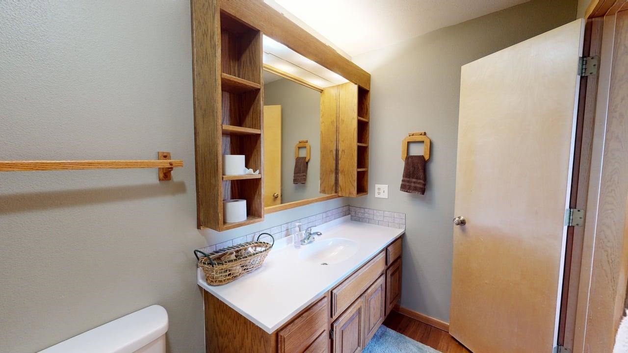 91200 Ryan Gulch Road, Unit 213 Silverthorne, CO 80498 - Photo 19 of 33 a bathroom with a sink vanity and a mirror