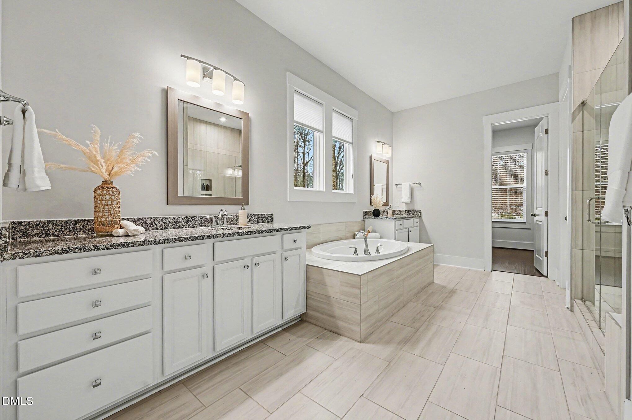 1017 Fortune Lane Mebane, NC 27302 - Photo 13 of 84 a spacious bathroom with a granite countertop sink and a mirror