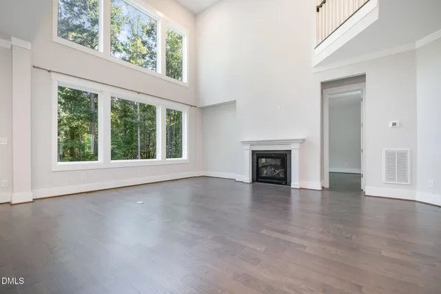 a open kitchen with granite countertop a stove top oven a sink and dishwasher with wooden floor
