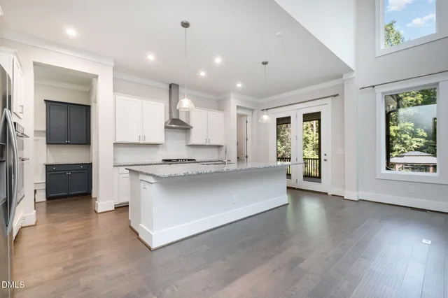 a large kitchen with kitchen island granite countertop a large counter top and stainless steel appliances