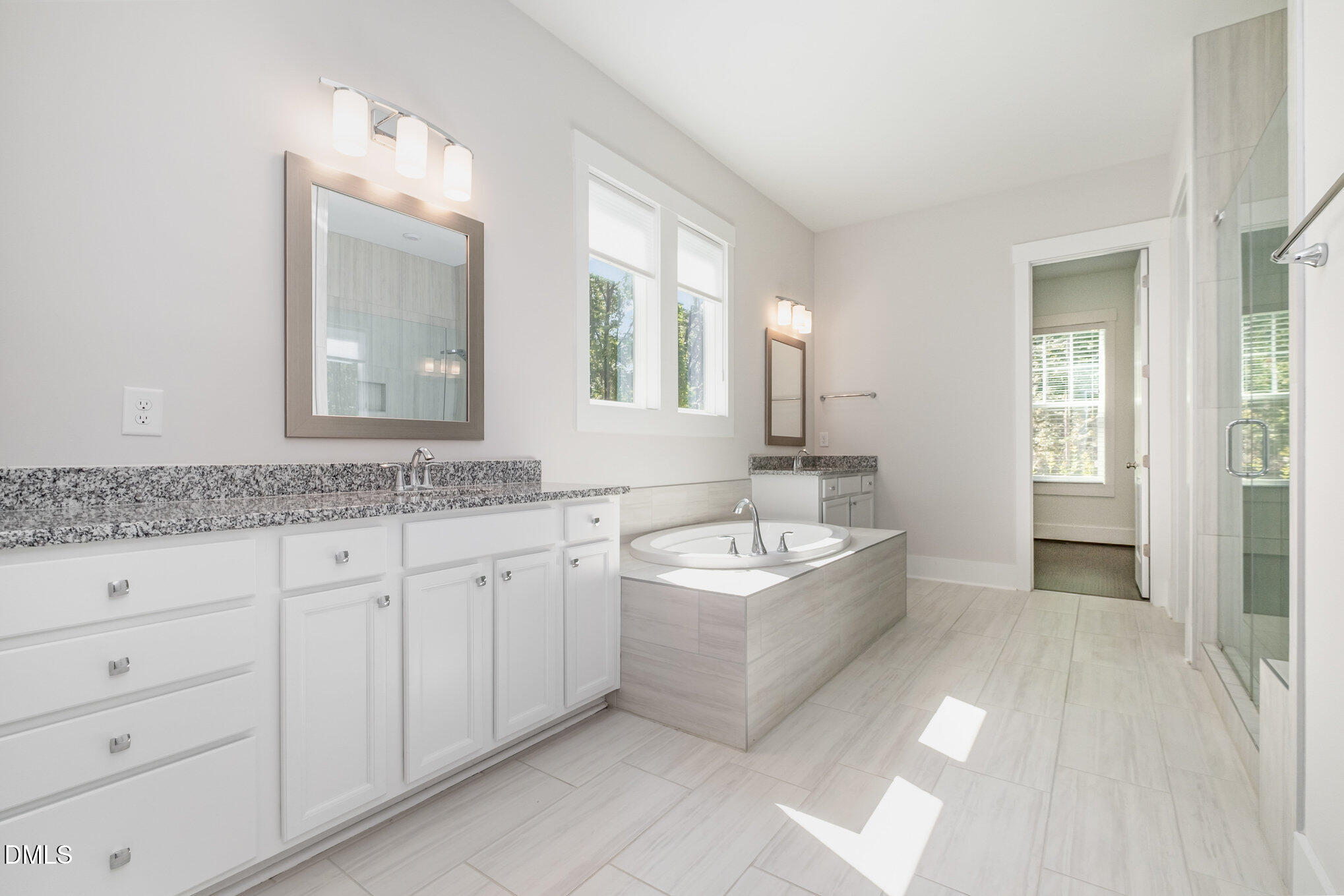 1017 Fortune Lane Mebane, NC 27302 - Photo 35 of 84 a spacious bathroom with a granite countertop sink mirror and bathtub