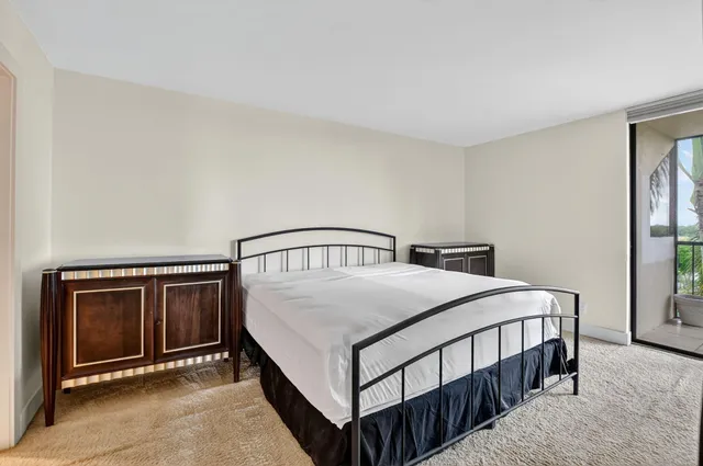a bathroom with a granite countertop toilet sink shower and mirror