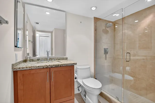 an aerial view of a house with swimming pool a yard and lake view