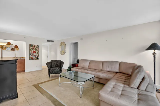 a bathroom with a granite countertop sink mirror vanity bathtub and toilet