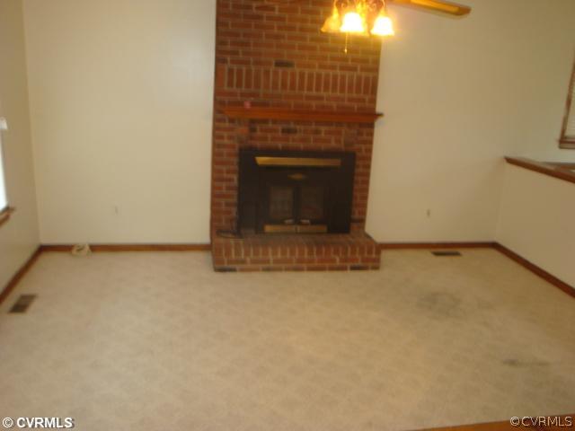 11011 Drayton Road Chester, VA 23831 - Photo 3 of 5 a view of an empty room with a fireplace