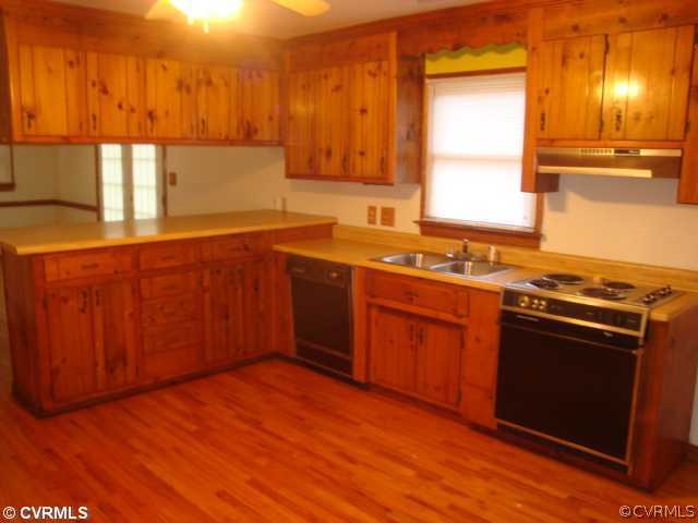 11011 Drayton Road Chester, VA 23831 - Photo 5 of 5 a kitchen with stainless steel appliances granite countertop a stove a sink and a microwave