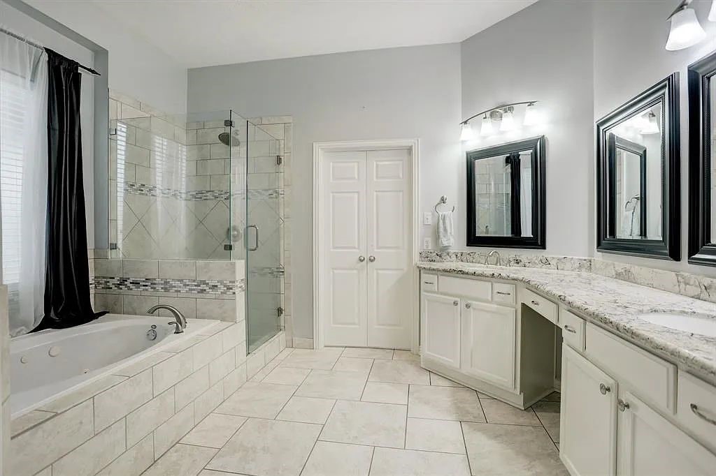 10147 Lazy Lagoon Houston, TX 77065 - Photo 11 of 15 a spacious bathroom with a granite countertop sink mirror and shower