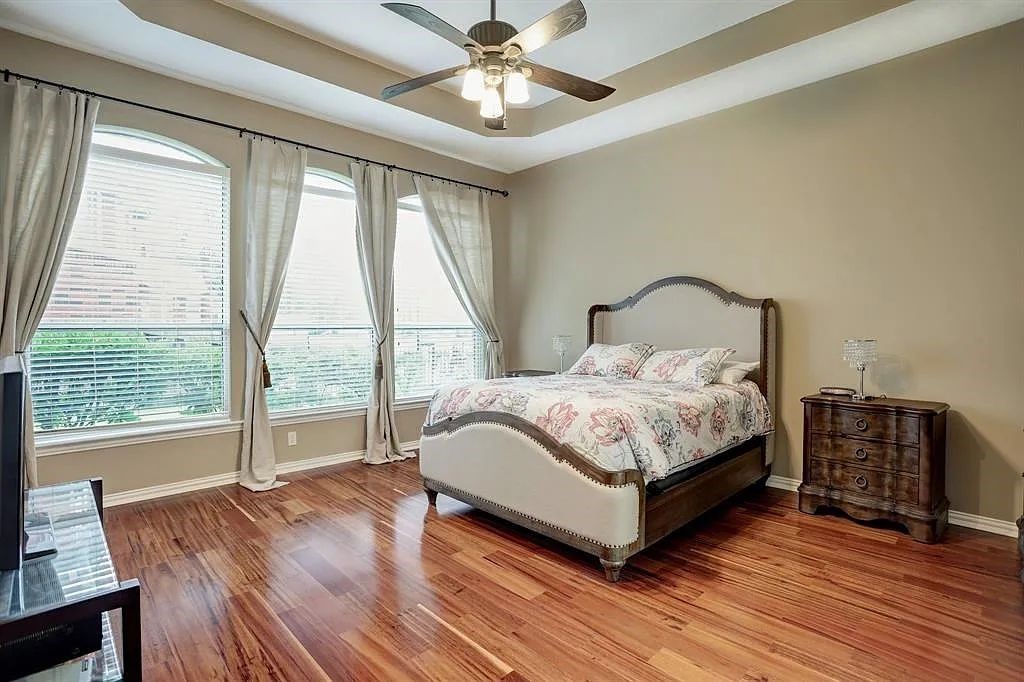 10147 Lazy Lagoon Houston, TX 77065 - Photo 10 of 15 a bed sitting in a spacious bedroom next to a window