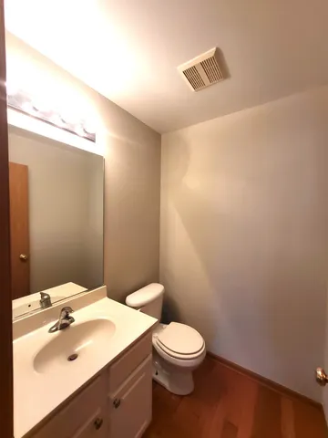 a bathroom with a sink a toilet and mirror