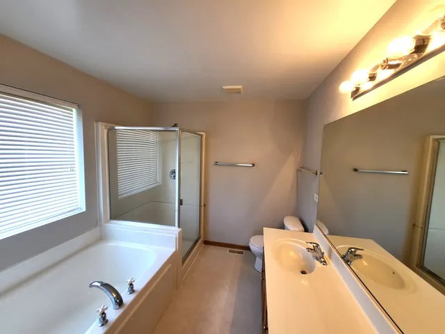 a bathroom with a tub sink and mirror