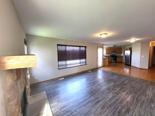 a view of a livingroom with furniture and wooden floor