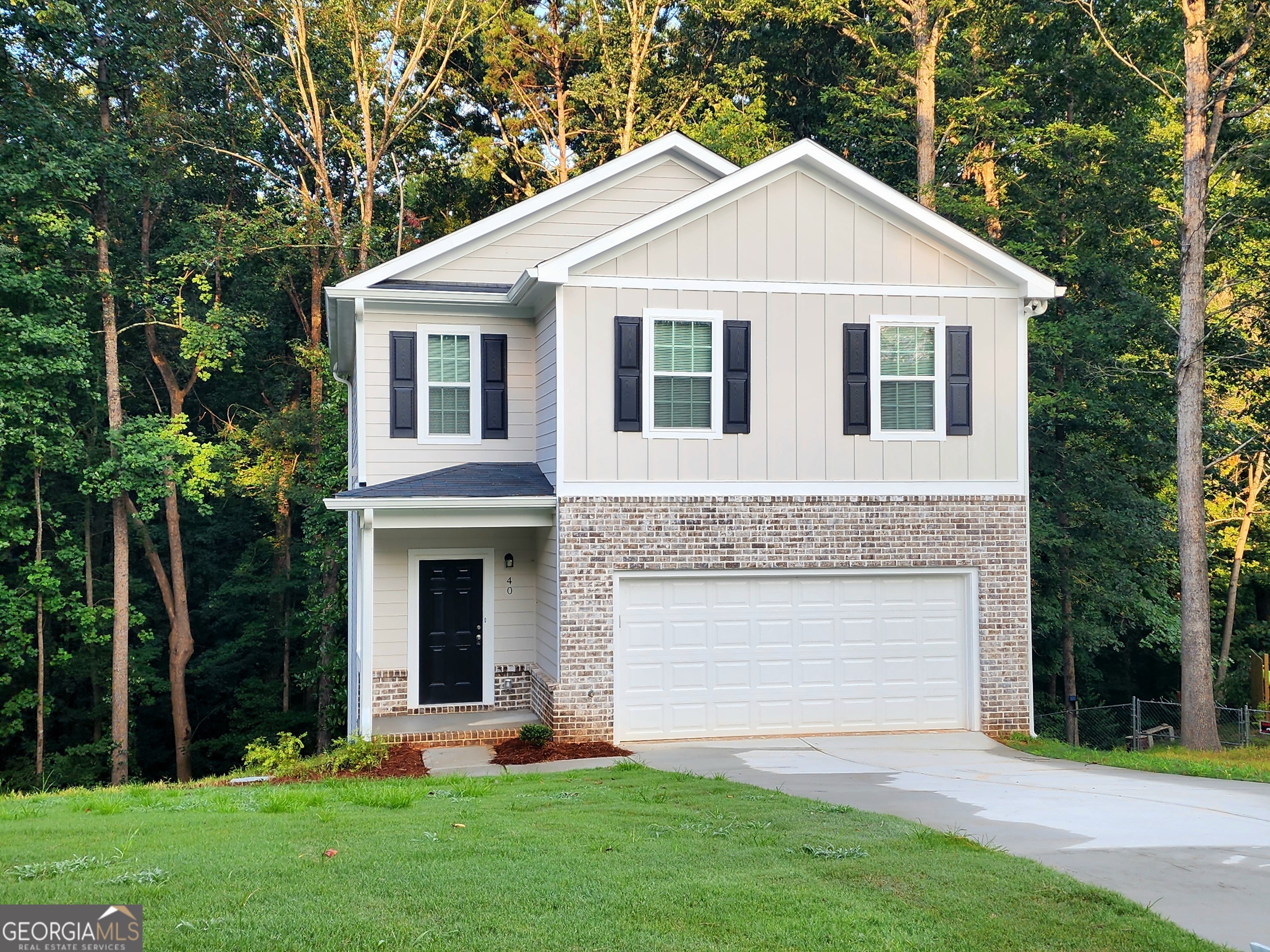 a front view of a house with a garden and plants