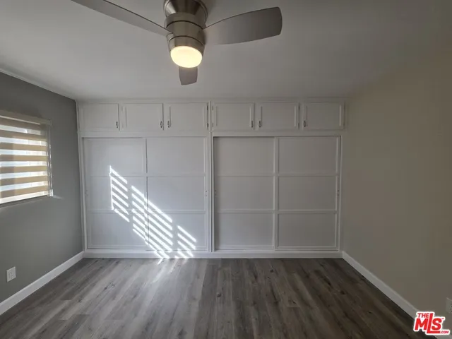 a view of hallway with wooden floor