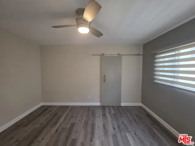 a view of bathroom with wooden floor and mirror