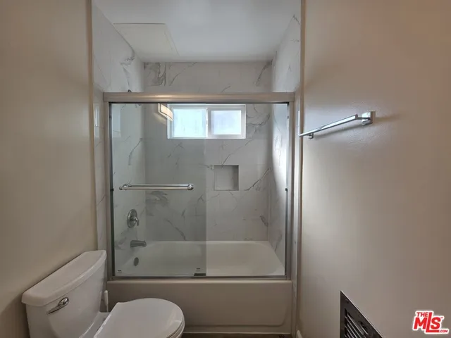 a bathroom with a sink a mirror and a shower