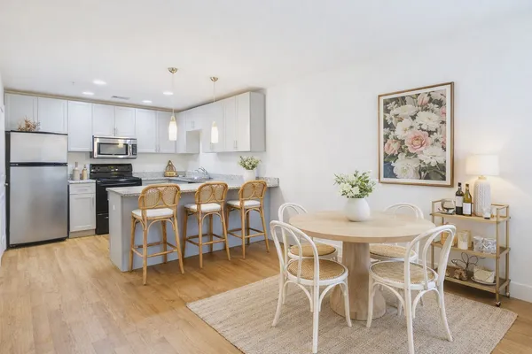 a view of a dining room with furniture and wooden floor