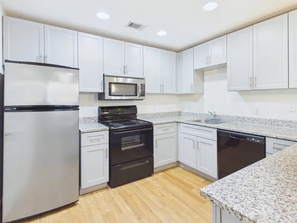 a kitchen with a sink stove and refrigerator