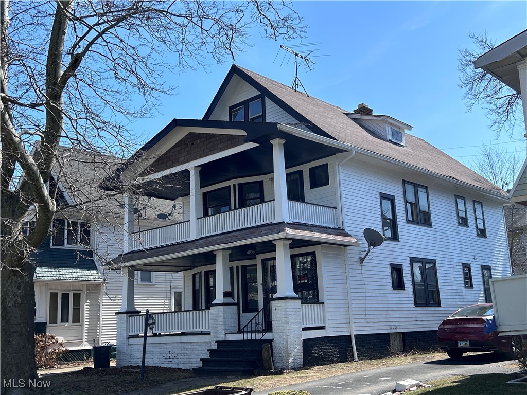 13412 Graham Road Cleveland, OH 44112 - Photo 2 of 18 View of front of home featuring a balcony, a shingled roof, and covered porch