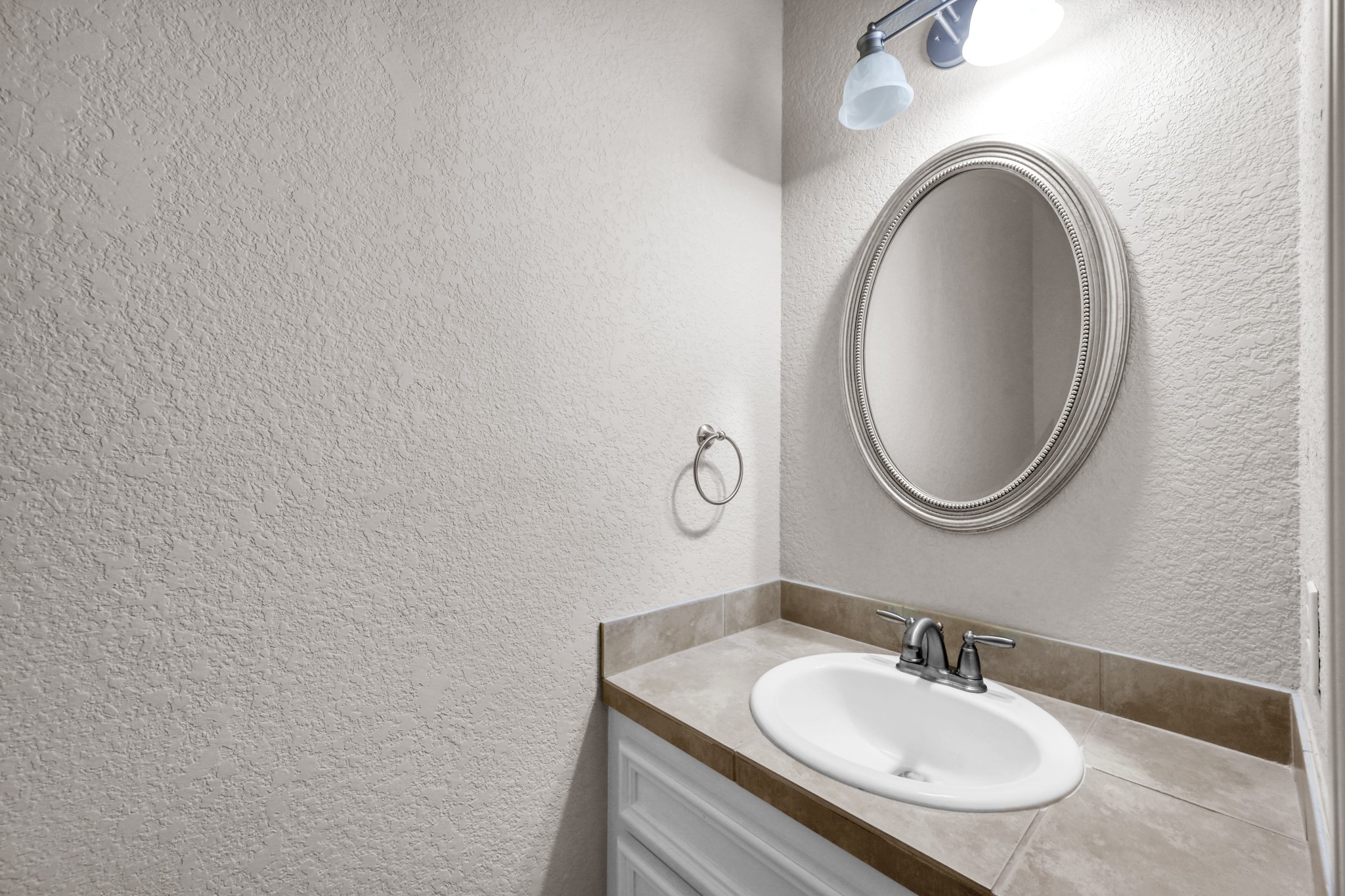 130 April Cove Conroe, TX 77356 - Photo 17 of 36 a bathroom with a sink and a mirror