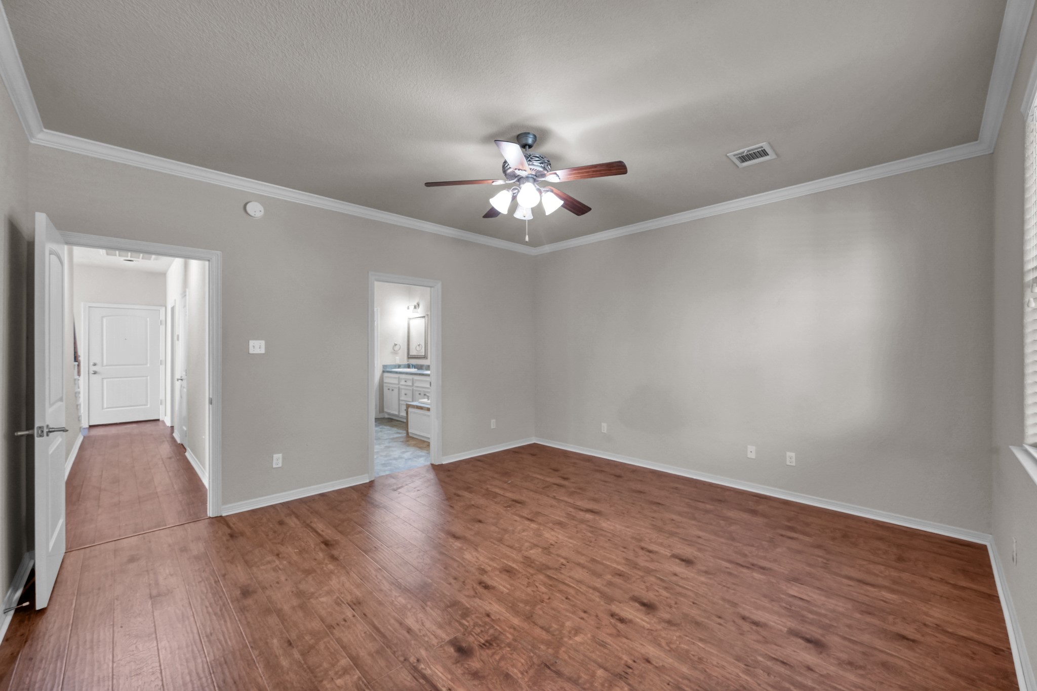 130 April Cove Conroe, TX 77356 - Photo 21 of 36 a view of an empty room with chandelier fan and wooden floor