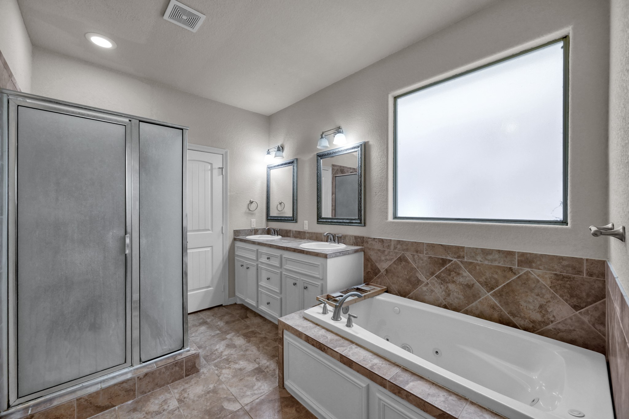 130 April Cove Conroe, TX 77356 - Photo 22 of 36 a bathroom with a tub a sink and mirror