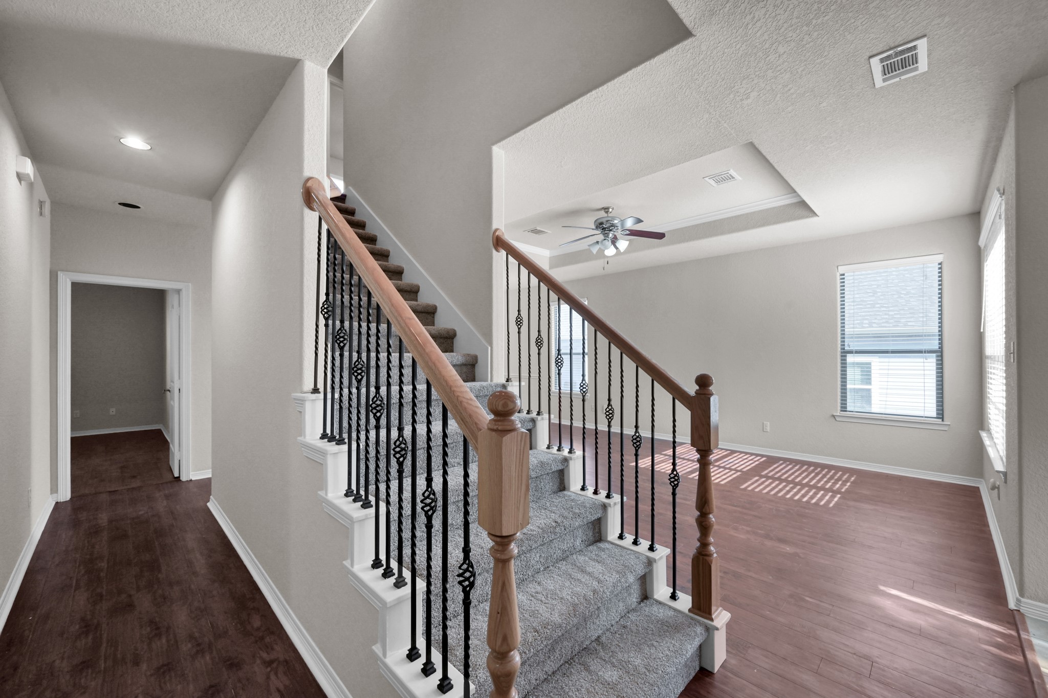 130 April Cove Conroe, TX 77356 - Photo 25 of 36 a view of a hallway with wooden floor and stairs