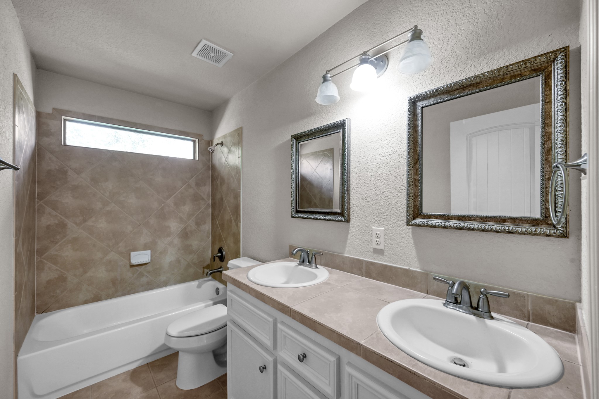 130 April Cove Conroe, TX 77356 - Photo 30 of 36 a bathroom with a granite countertop toilet a sink and a mirror