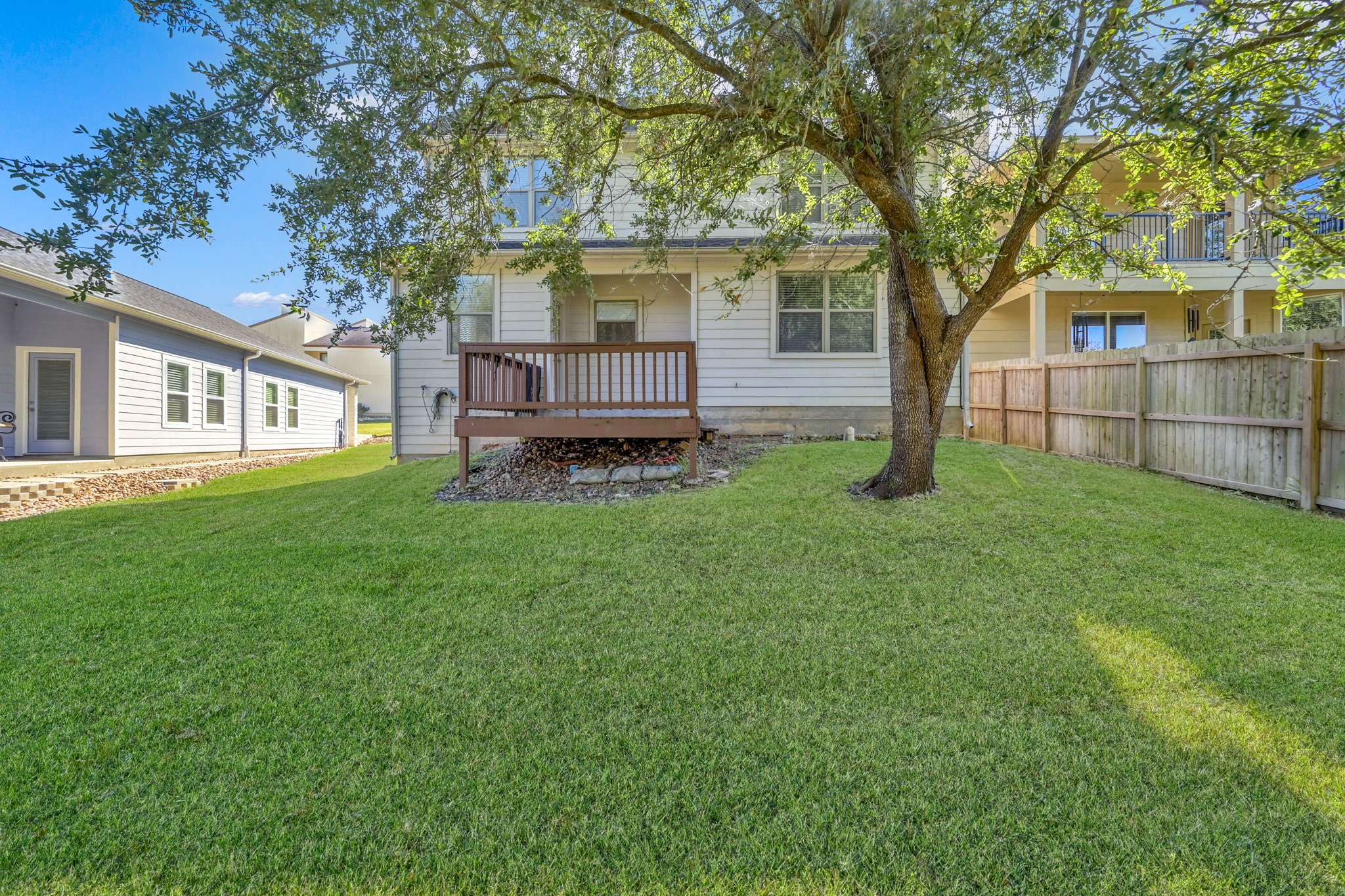 130 April Cove Conroe, TX 77356 - Photo 33 of 36 a white house that has a tree in front of a house