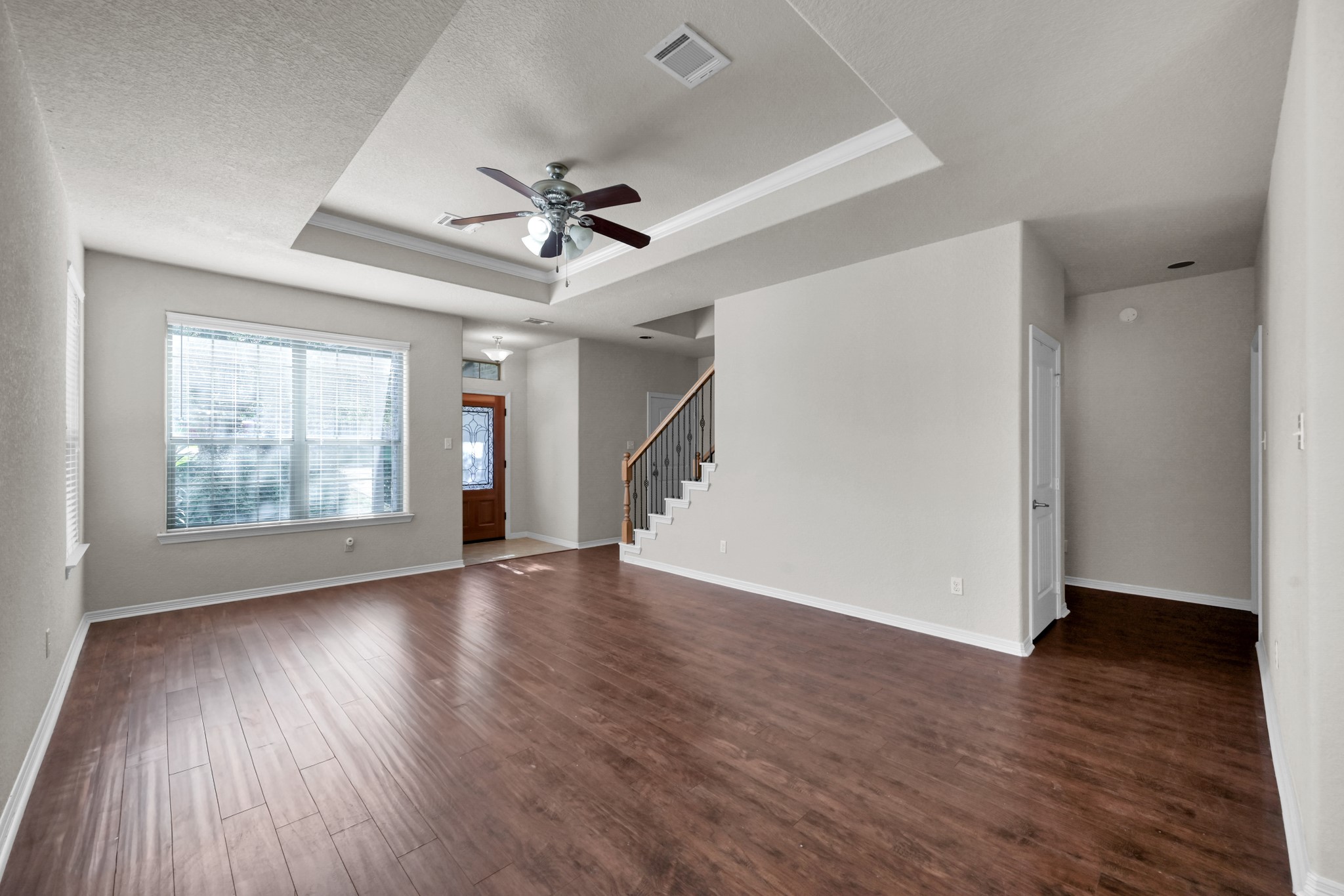 130 April Cove Conroe, TX 77356 - Photo 8 of 36 a view of an empty room with wooden floor and a window