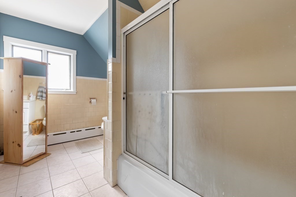 6 Harvard Street Gloucester, MA 01930 - Photo 12 of 19 a bathroom with a glass shower door
