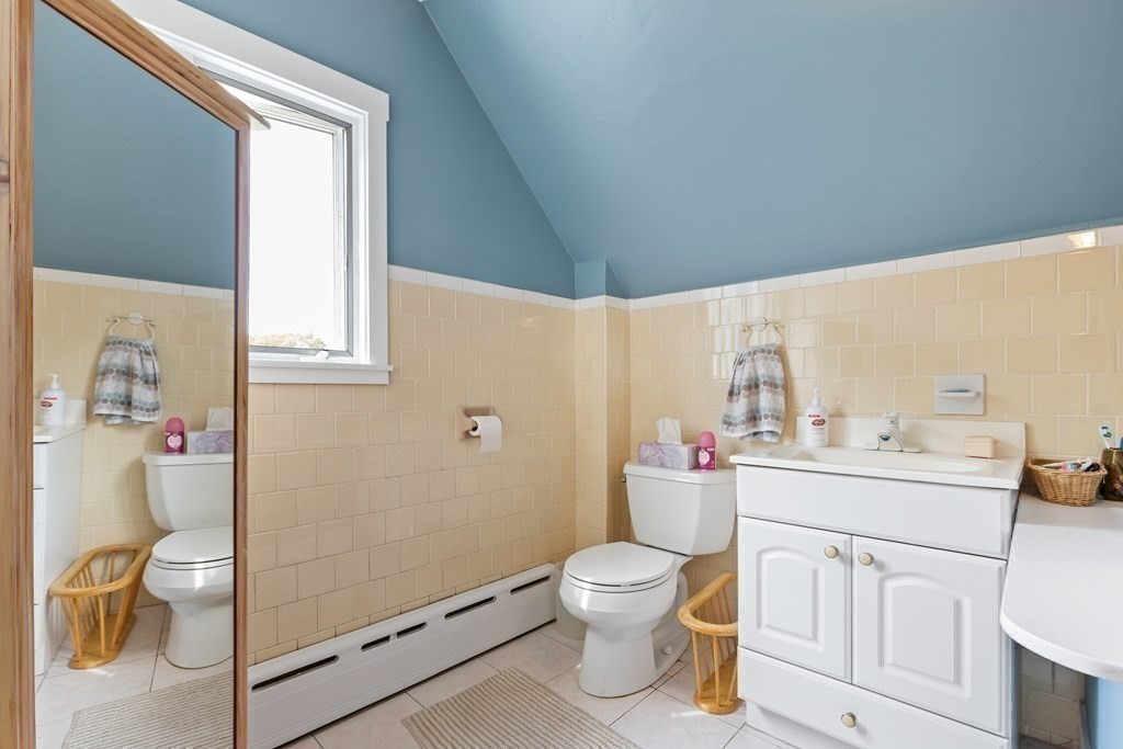 6 Harvard Street Gloucester, MA 01930 - Photo 13 of 19 a white toilet sitting next to a bathroom sink